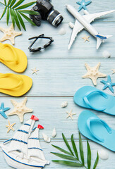Summer vacation accessories forming a frame on wooden background