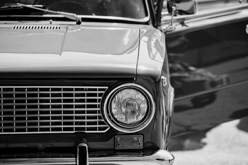 black and white front view of vintage retro car with open door classic automobile headlight and...