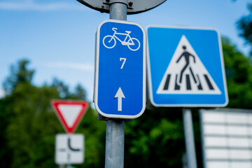 bicycle route sign number 7 and pedestrian crossing symbol with yield and curved road signs in...