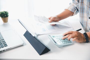 Woman calculating monthly home expenses, taxes, bank account balance and credit card bills payment,...