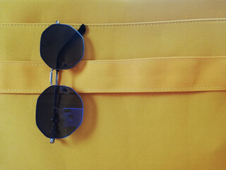 Fototapeta premium glasses on yellow bag