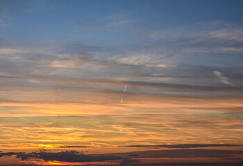 Sunset glow on clouds with a golden and warm blue gradient