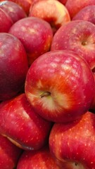 Close up pile of tasty fresh apples sold at the market as a background.
