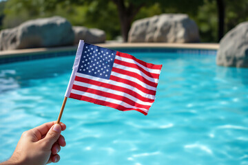 person holding an American flag in front of a swimming pool