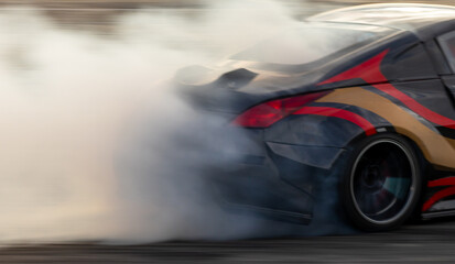Car drifting, Blurred image diffusion race drift car with lots of smoke from burning tires on speed track, Car drifting on speed track, Professional driver driv drifting car. © Kalyakan