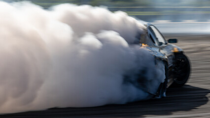 Car drifting, Blurred image diffusion race drift car with lots of smoke from burning tires on speed...