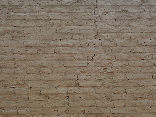 Old Brick Wall with Visible Cracks Painted in Brownish Clay Color