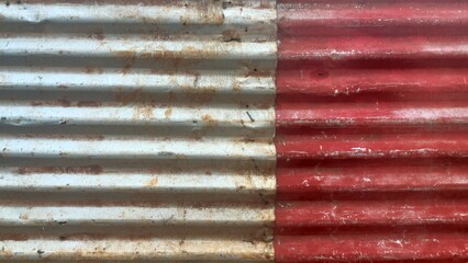 lang="x-default" Red and white corrugated iron sheet metal forms a weathered background