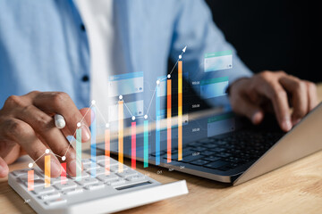 Obraz na płótnie Canvas Business accounting and planning strategy for financial growth. Person using calculator and laptop to analyze profit charts, investment trends, and monthly financial performance in digital dashboard.