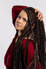A Beautiful Young Woman with Intricate Braids Posing Elegantly in a Fashionable Outfit