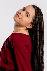A Graceful and Elegant Woman Wearing a Stunning Maroon Dress with Long Braided Hair