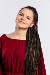 A Smiling Young Woman With Elegant Braided Hair Dressed in a Beautiful Burgundy Dress
