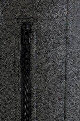 A CloseUp Image Featuring a Stylish Black Zipper on a Soft Gray Fabric Material