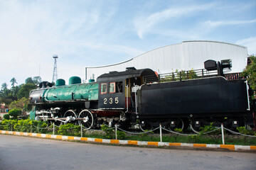 Antique model local bogie Steam locomotive on track railway for show thai people travelers travel visit at front of vintage building retro architecture of Chumphon train station in Chumphon, Thailand