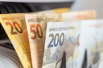 Brazilian money, Brazil real, banknotes in a money counter, financial concept