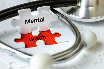 Mental Health word on the exposed puzzle. Mental health assessment, child well-being, Stress at...