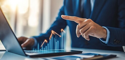 Businessperson analyzing upward-trending graph on laptop
