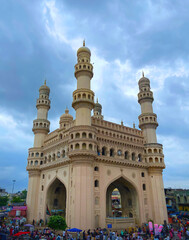 Charminar Monument in Hyderabad Under Dramatic Cloudy Sky with City Crowd