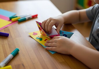 Child making origami craft