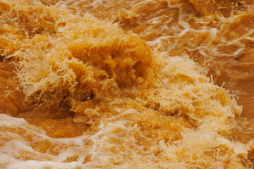 Brown water with ripples on the surface. Defocus blurred transparent brown colored clear calm water...