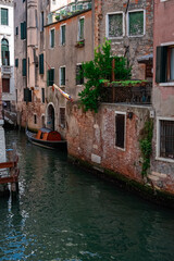 Gondola Resting in Quiet Venetian Canal – Hidden Gem Framed by Rustic Architecture and Reflections