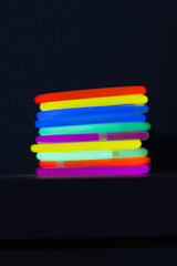 Fototapeta premium neon bracelets glow sticks in the dark