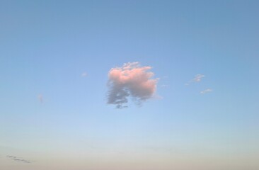 heart shaped cloud.
pink-gray cloud high in evening summer sky