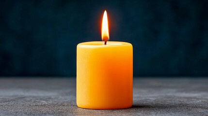 Bright yellow candle flickering softly enhances ambient lighting in a cozy indoor space during evening hours
