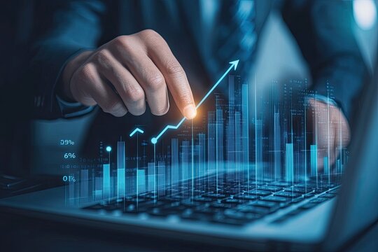 Businessperson interacting with glowing financial graphs on laptop
