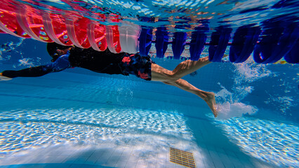 Professional male watersport ,which Slim sportsman swimming in a pool at summer vacation 