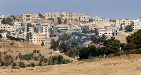 Obraz premium Houses, a street and trees northwest of the capital, Amman, near the old city of Salt.