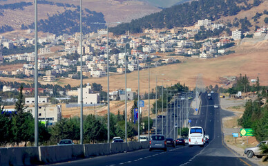 Houses, a street and trees northwest of the capital, Amman, near the old city of Salt.