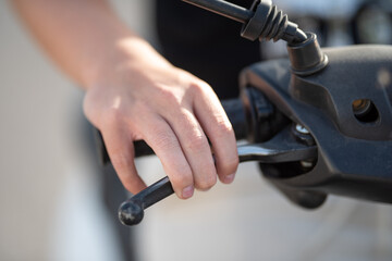 Close-up of a hand gripping the throttle of a motorcycle, showcasing the intricate details of the...