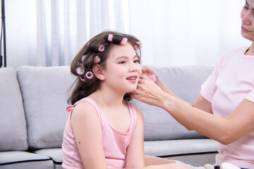 Kids, cosmetic, child, beauty, makeup, A girl with hair curlers drinks dairy from a glass while her...