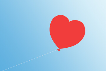 Fototapeta premium Red heart balloon floating in a blue sky