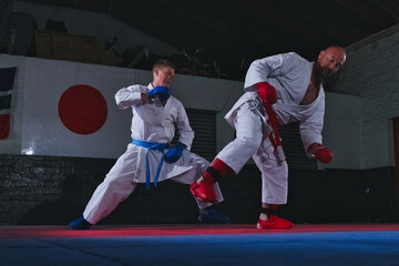 Teenage Boy Practicing Karate with His Father and Instructor