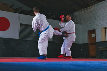 Teenage Boy Practicing Karate with His Father and Instructor