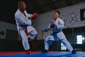 Teenage Boy Practicing Karate with His Father and Instructor