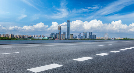 Empty asphalt road and modern city skyline with commercial buildings scenery in Suzhou, China.