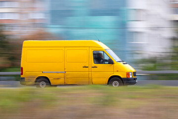 Yellow delivery van on the road