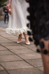 Wedding day. Close-up of bride legs, white ruffled dress and elegant heels . Wedding inspiration, bridal accessories 