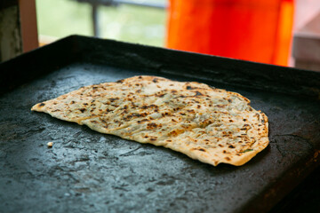 Selling and preparing gozleme with spinach at the Turkish market in Kreuzberg, Berlin.