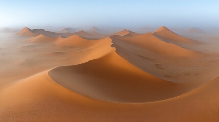 Vast desert dunes bathed in soft morning light, hazy atmosphere