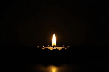 Fototapeta premium Single Candle Illuminates Black Background with Warm Glow, Creating Peaceful light isolated