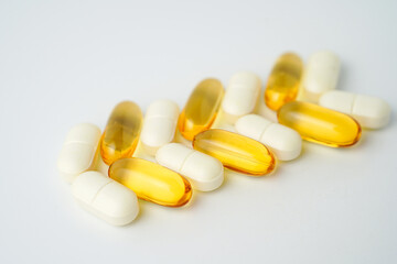 Clock made of pills capsules, pills form a circle, omega, vitamins, Cod liver oil, supplements