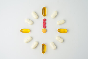 Clock made of pills capsules, pills form a circle, omega, vitamins, Cod liver oil, supplements
