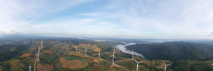 Aerial view of powerful Wind turbine farm for energy production on beautiful cloudy sky at...