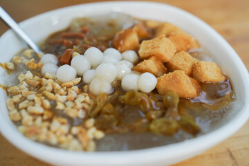 A refreshing bowl of Glutinous Rice Cake, peanuts, Raisins, jelly dessert with ice.