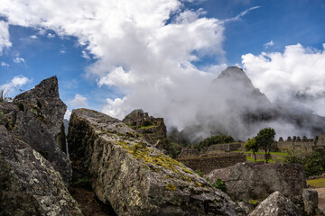 Panoramic view of Machu Picchu ruins surrounded by misty mountains, Peru