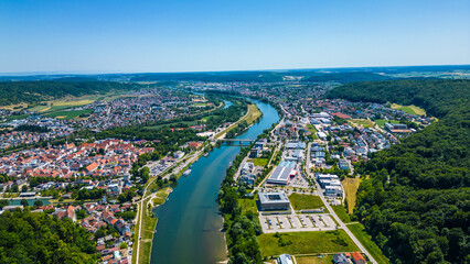 Befreiungshalle in Kelheim, Germany, captured from a drone on a bright summer day. This impressive circular monument stands above the Danube, surrounded by lush green landscape